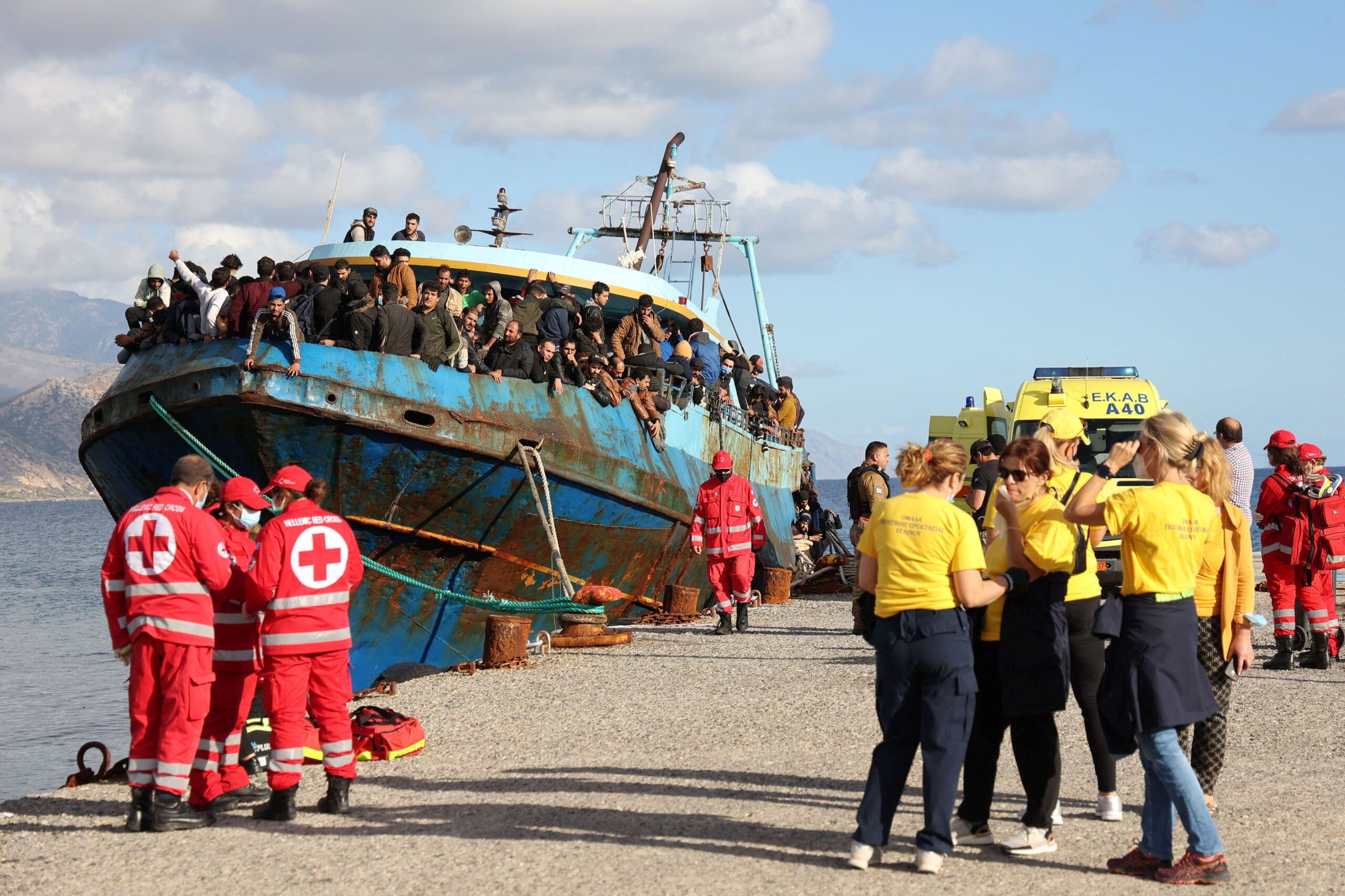 FILE - A fishing boat with some 500 migrants enters the southern