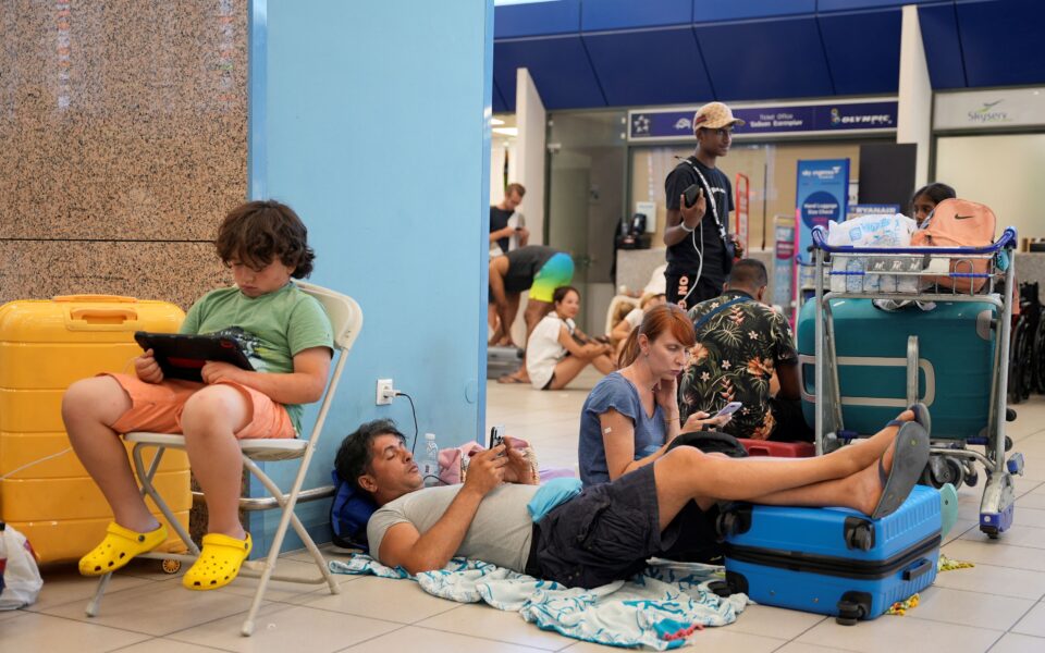 Tourists wait for departing planes in Rhodes