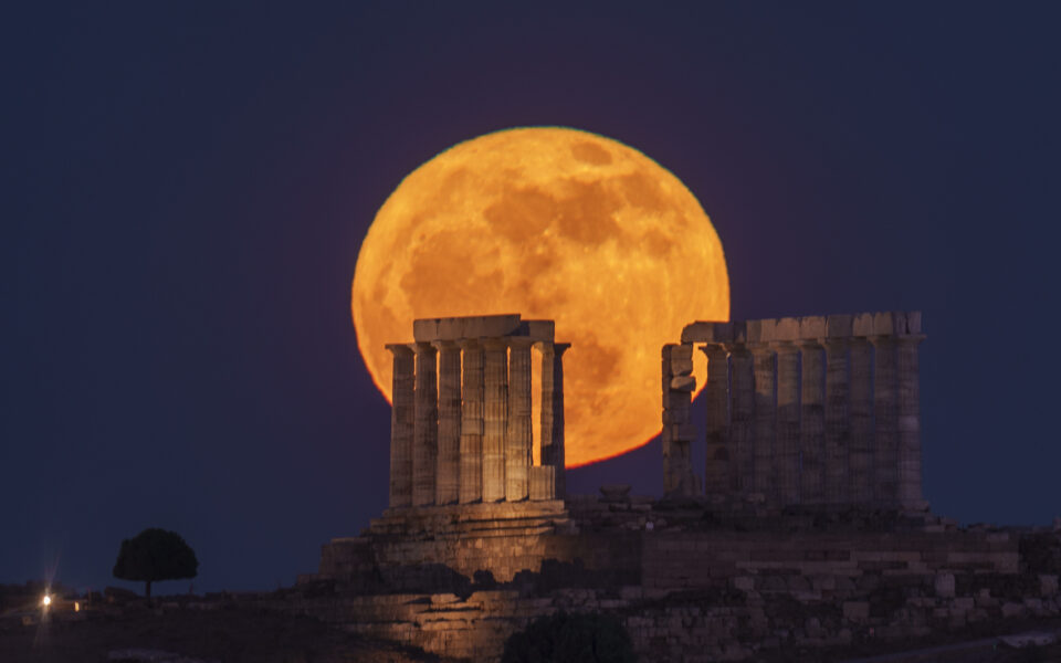Full moon rises behind Temple of Poseidon at Cape Sounio