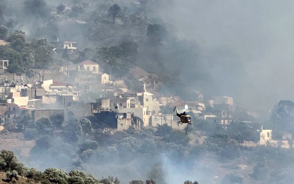 Greece flies more firefighters to battle a blaze on Crete, and orders new evacuations