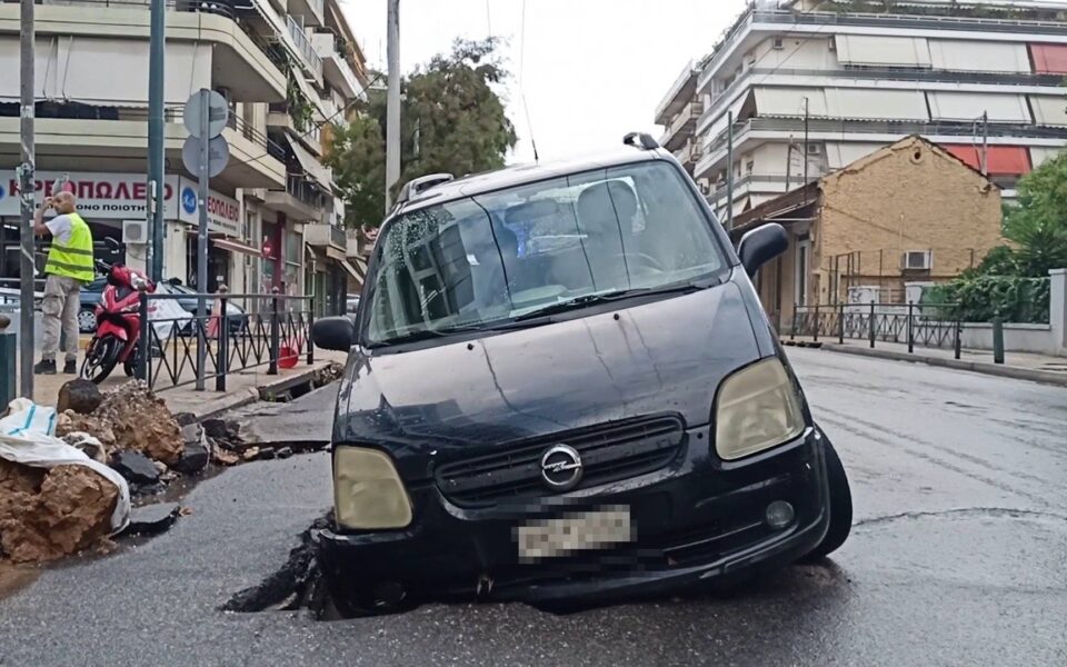 Car stuck after pothole appears in Athens street amid heavy rain