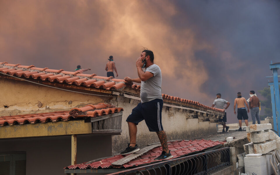 Drop in winds offers hope as firefighters battle huge wildfire on fringes of Athens, one dead