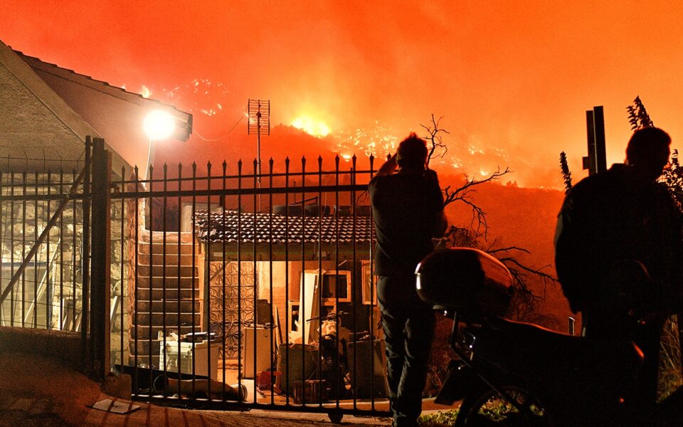 Wildfire rages near seaside town in central Greece, two bodies recovered